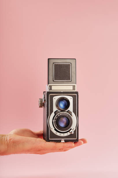 istock Hand holding a vintage twin lens reflex (TLR) medium format camera with waist level finder 2193831754