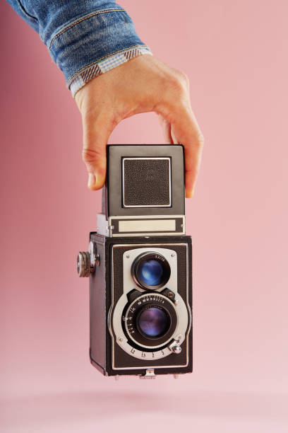 istock Hand holding a vintage twin lens reflex (TLR) medium format camera with waist level finder 2193831855