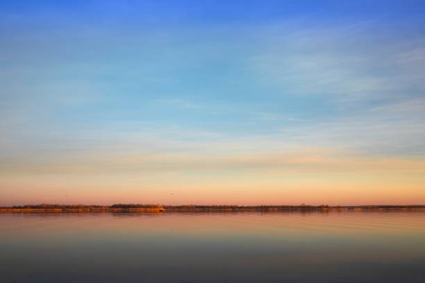 istock Lake Surface at Sunset with Golden Reflections and Gentle Sky Colors 2193831894