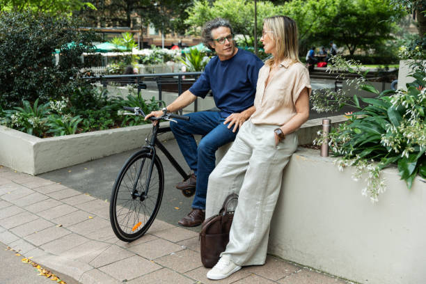 istock Mature aged couple chat in the park 2193833567