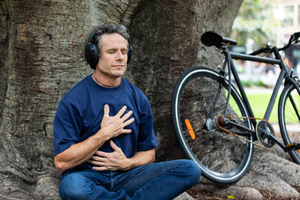 Mature aged man takes a mindful break in the park