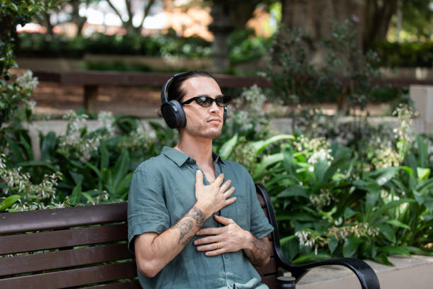 istock Young non-binary adult takes a mindful break in the park 2193834339