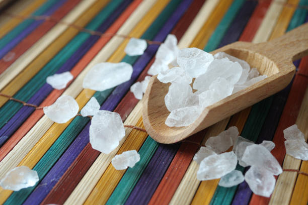 istock Coarse Sea Salt arrayed beautifully on a vibrant and colorful Bamboo Mat surface 2193834425
