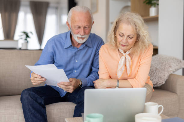 istock Senior Couple Enjoying Time with Laptop and Documents Together 2193835093