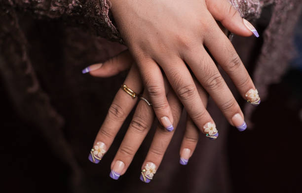 istock A bride's hand is using nail art for her wedding event 2193835785