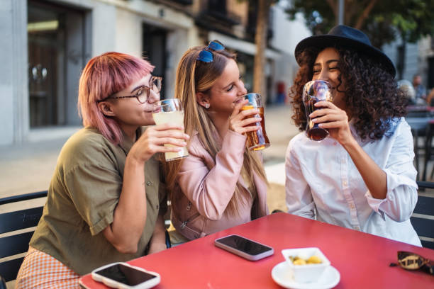istock Three young women drinking and having fun at outdoor cafe 2193838605