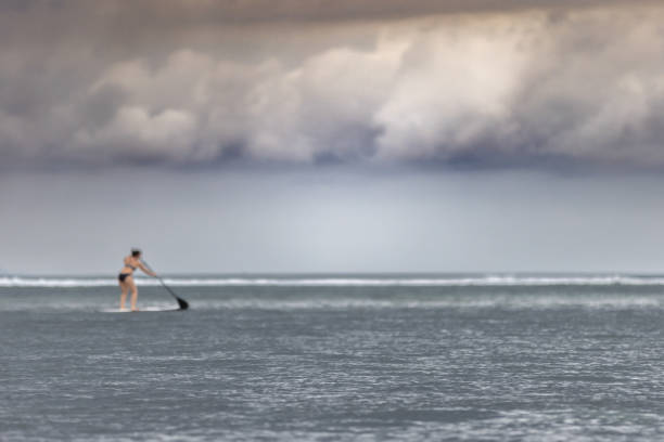 A woman is paddle boarding on the sea.Sanur beach, Denpasar - Bali Island.