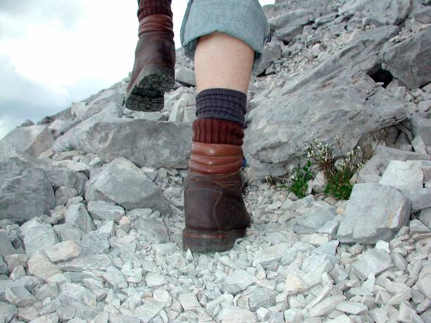 Close up view of hiker female walking on mountain trail towards the famous Matterhorn mountain in Zermatt, Switzerland.