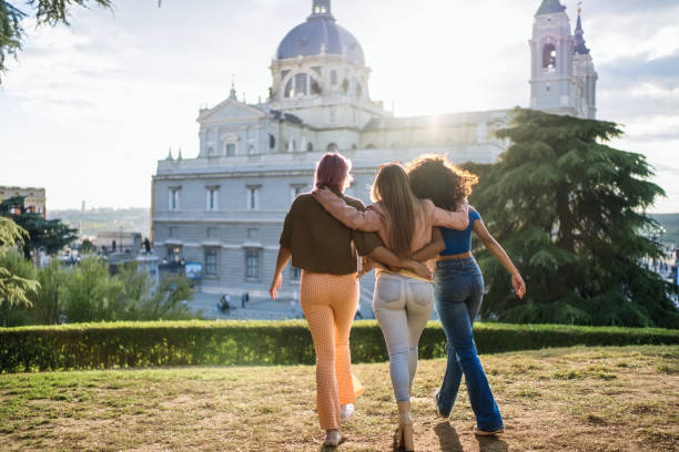 istock Three young women walking together in a park 2193840838