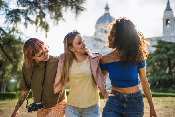 istock Three young women walking together in a park 2193840854