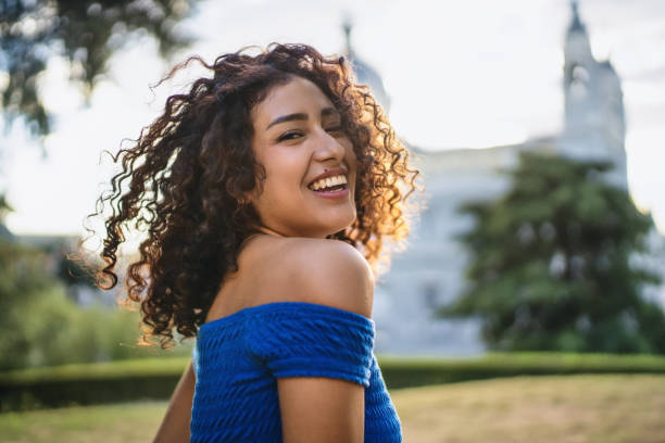 istock Young latin woman smiling in a park 2193840897