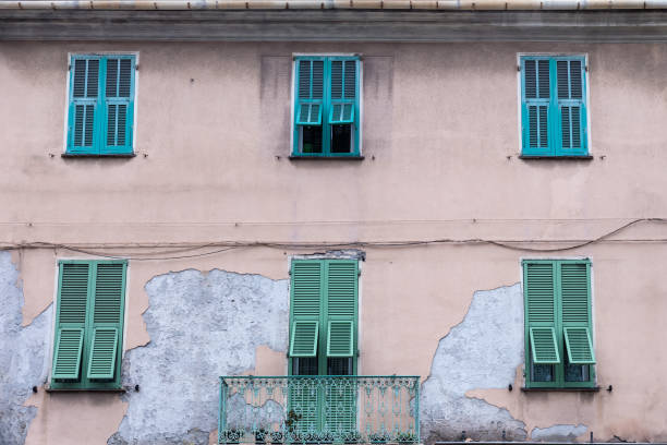 istock Old three-story building with windows with wooden exterior shutters 2193840971