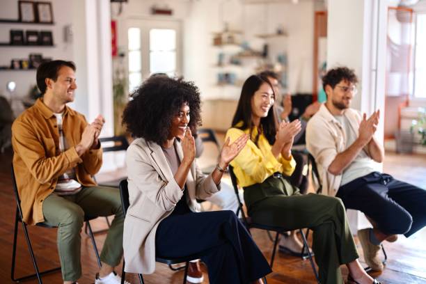 istock Smiling people applauding at the end of a panel discussion 2193841894