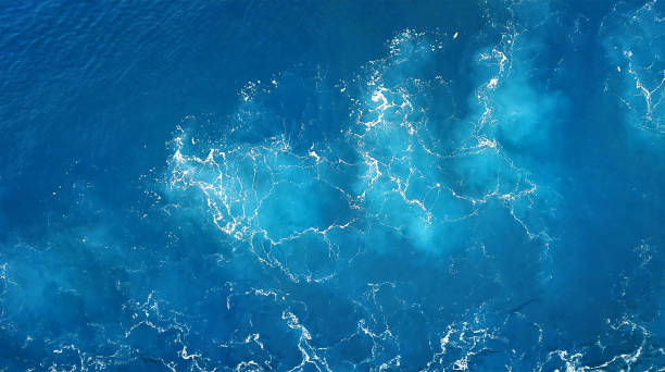istock ocean water, with a white pattern of waves splashing in the deep blue sea. 2193841909