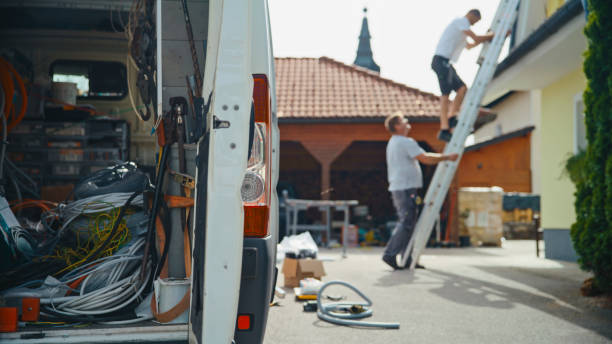 istock Male Electrician Working On Ladder Near Van 2193843556
