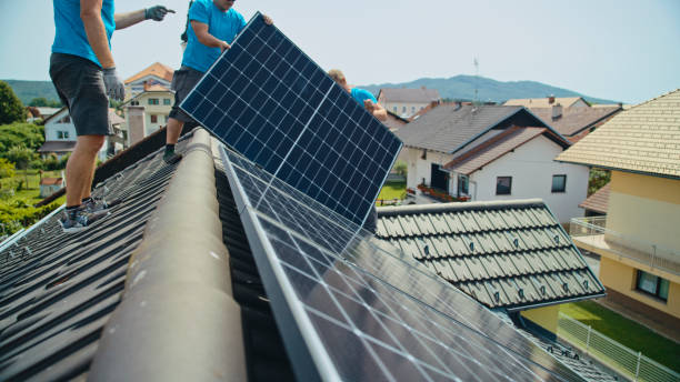 istock Caucasian Male Workers Installing Solar Panels On Rooftop 2193843616