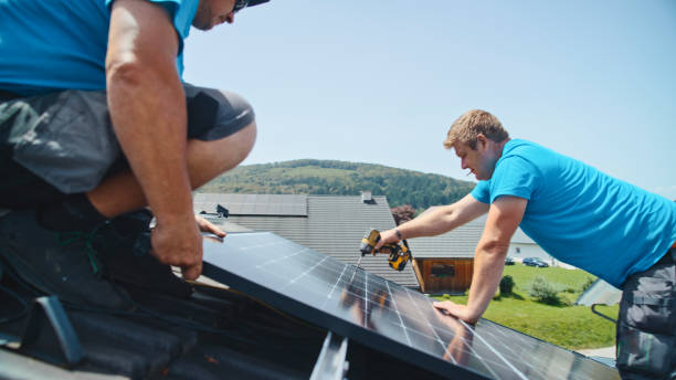 istock Caucasian Male Professionals Installing Solar Panels On Rooftop 2193843806