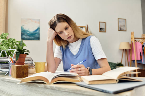 istock Modern teenager studying in a cozy apartment during the evening light 2193844013