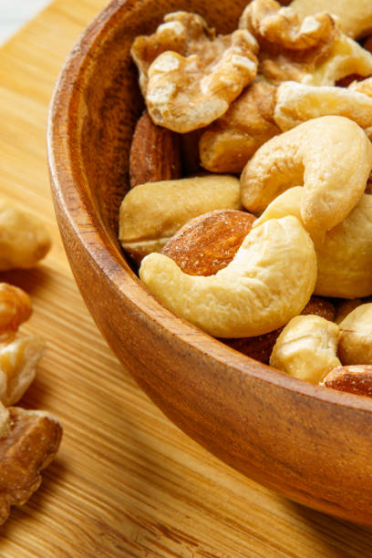 istock Assortment of nuts in wooden bowl 2193845695