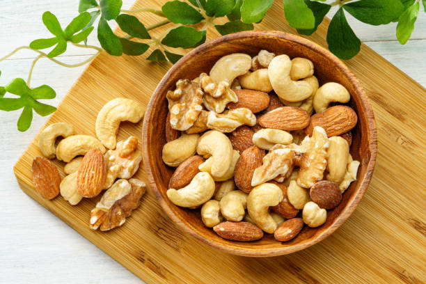 istock Assortment of nuts in wooden bowl 2193845715