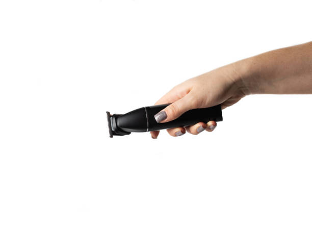 istock Female hand with a hair trimmer on a white background, isolate, close-up 2193845824