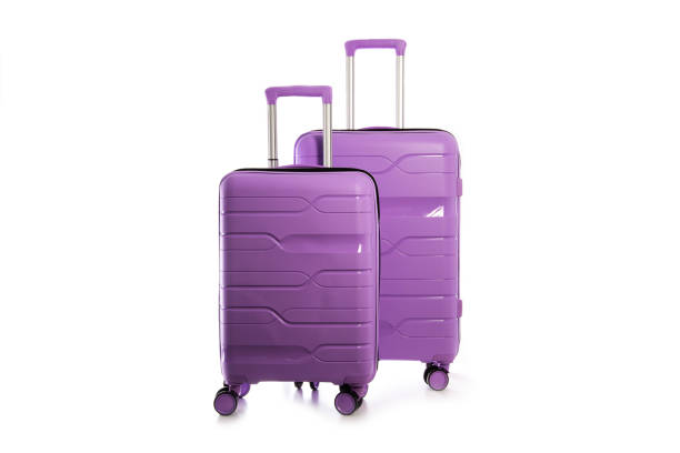 istock Two modern purple plastic suitcases on a white background, close-up, isolate 2193845836