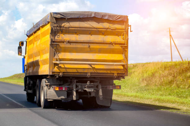 istock A yellow dump truck transports grain from the fields with a closed awning. Import and export of grain, transportation of agricultural products. Copy space for text 2193846673