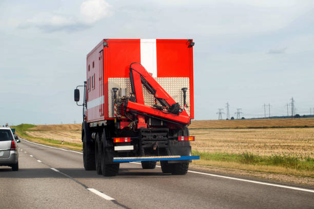 istock A special fire truck with a manipulator crane driving along a highway in summer, copy space for text 2193846691