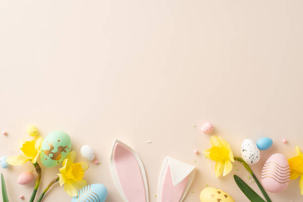 istock Bright and festive Easter decoration with colorful eggs, bunny ears, and daffodils on pastel backdrop 2193847879