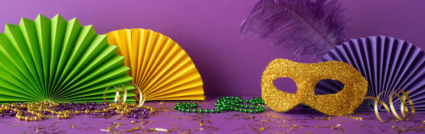 istock Decorative side view elements for Mardi Gras including masks, feathers, beads in traditional colors 2193847970