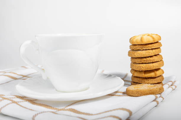 Danish cookies on a white background with coffee in a white cup, freshly brewed American coffee, isolate, breakfast, pastries, delicious shortbread cookies, catalog photo of food, coffee in bed