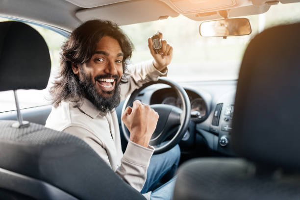 istock Happy driver celebrating after successfully passing a driving test in a car 2193856217