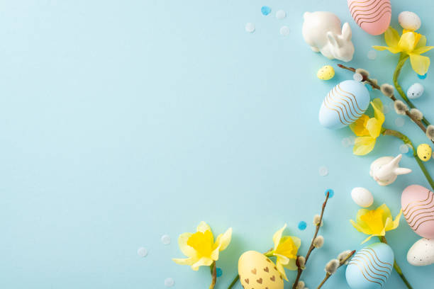 istock Festive Easter composition featuring pastel eggs, yellow daffodils, and ceramic bunnies on a soft blue background, perfect for seasonal and holiday-themed projects 2193856382