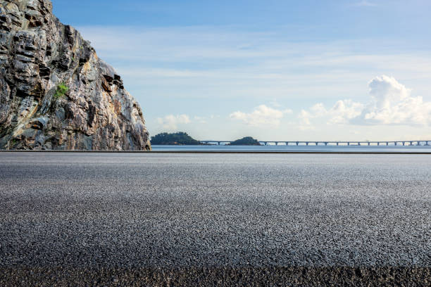 istock Asphalt road and mountain with coastline scenery under blue sky 2193858614