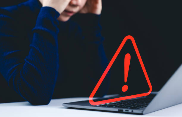 istock Warning alert system concept. A woman working on the computer, hacked on the computer network, crime and virus, Malicious software, compromised information, illegal connection, data vulnerability, 2193865933