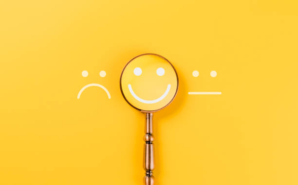 istock Customer feedback and Satisfaction survey concept. A magnifying glass highlighting a smile face amidst different emotions, customer review, satisfaction feedback, and service improvement. 2193866007