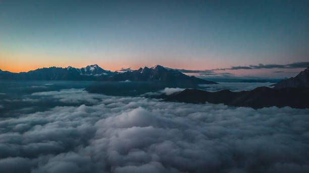 istock Dawn in the mountains above the clouds. 2193866331