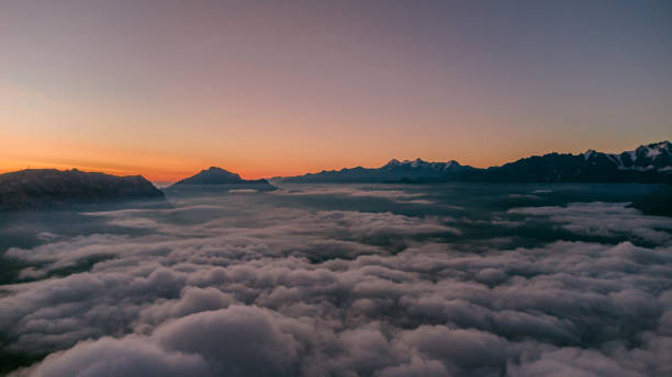 istock Dawn in the mountains above the clouds. 2193866334