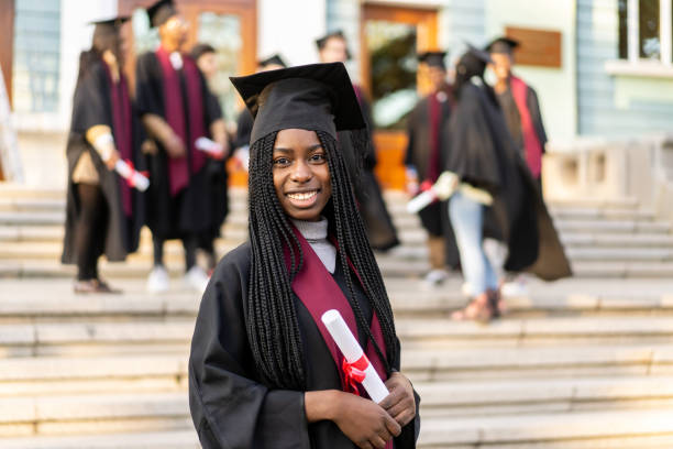 istock A female scholar is standing holding her diploma 2193866726
