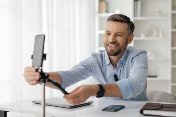 istock A man sets up his smartphone on a tripod while preparing for an online presentation in a bright office during the daytime 2193869326