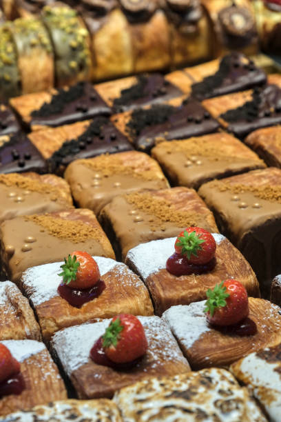 istock Square pastries dusted with powdered sugar, topped with fresh strawberries and jam 2193869488