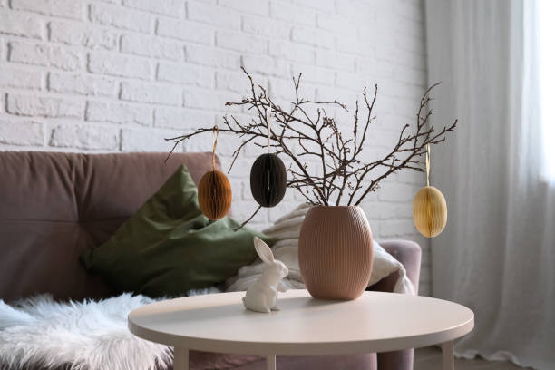istock A beautifully cozy living room with modern easter home decor that includes vase with dry branches and eggs, ceramic rabbit, on coffee table. 2193871859