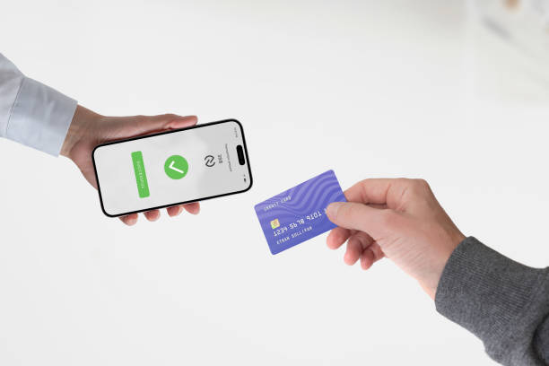 Credit card completing payment on a smartphone held by a vendor, with an NFC icon and a 
