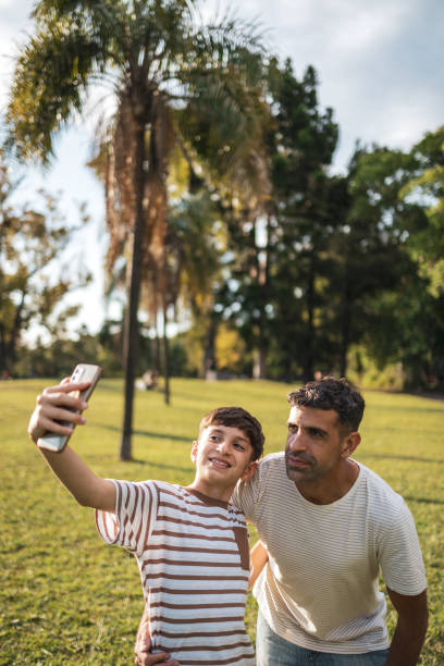 istock Father and son taking a selfie at the sunny park 2193874014