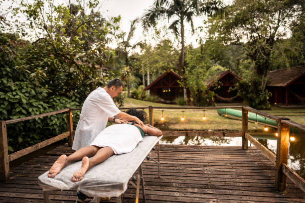 Senior massager man massaging customer outdoors