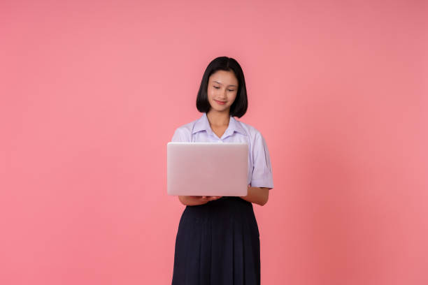 istock This Asian schoolgirl has her laptop in hand and is taking notes in her studio, knowing that her education will prepare her for the challenges and equip her with the knowledge to go to university. 2193880178