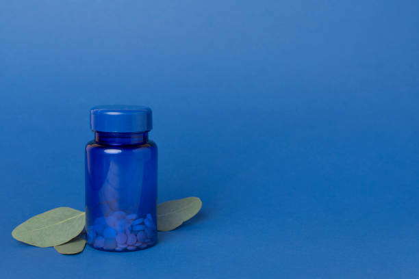 A vibrant health-themed image featuring an orange pill bottle and pink pills against a blue background, symbolizing healthcare, medicine, and pharmaceutical concepts.