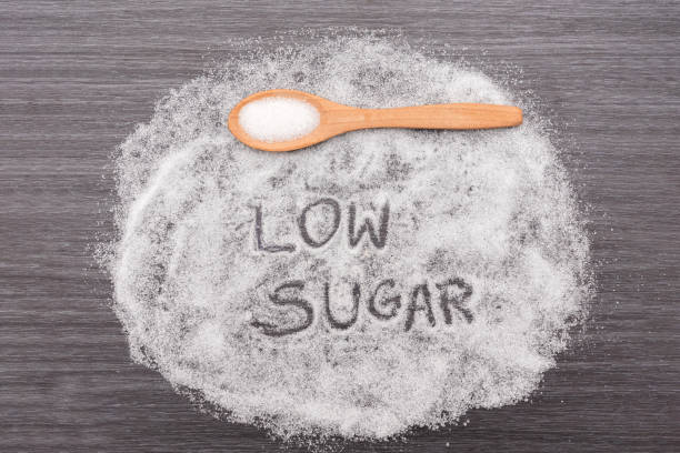 istock Wooden spoon with white sugar on gray background, Low sugar diet 2193880571