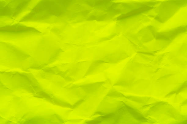 Close-up macro crumpled paper texture,Abstract light green paper texture as background. Texture of slightly crumpled craft paper. Paper background. Recycled green paper backdrop in close up. green Textures. Wallpaper.