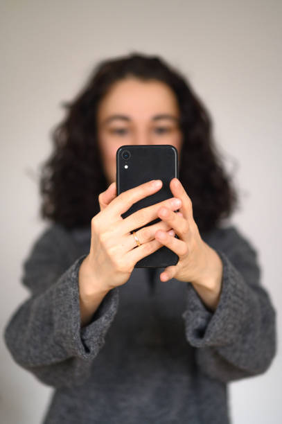 istock An isolated woman's portrait with a cell phone making selfie 2193884044